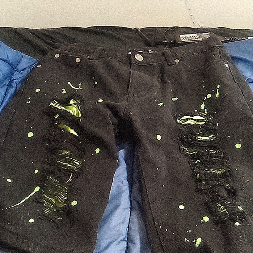 Riped shorts with green neon pain on it